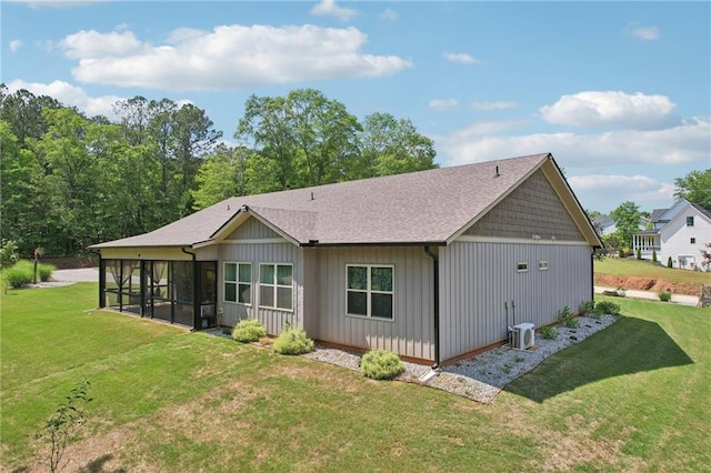 411 Johnson Rd, Locust Grove, GA 30248 - back of house featuring a sunroom, a lawn, board and batten siding, and roof with shingles