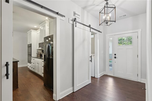 411 Johnson Rd, Locust Grove, GA 30248 - foyer with a barn door, dark wood finished floors, a chandelier, and recessed lighting