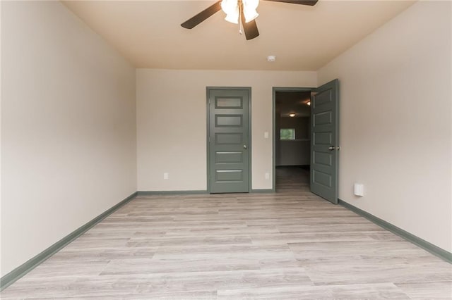 unfurnished bedroom featuring light wood-type flooring and ceiling fan