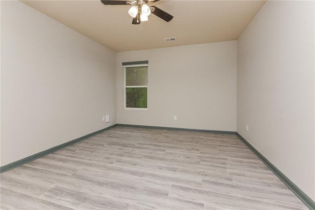 empty room with ceiling fan and light hardwood / wood-style floors