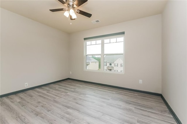 empty room with light hardwood / wood-style floors and ceiling fan