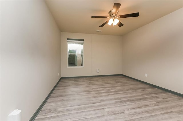 spare room with ceiling fan and light hardwood / wood-style floors