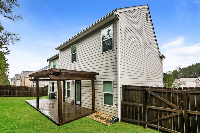 rear view of property featuring a pergola, a patio area, and a lawn