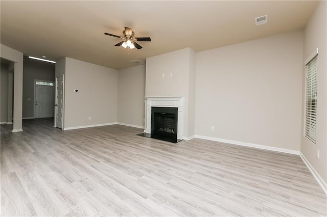 unfurnished living room with ceiling fan and light hardwood / wood-style floors