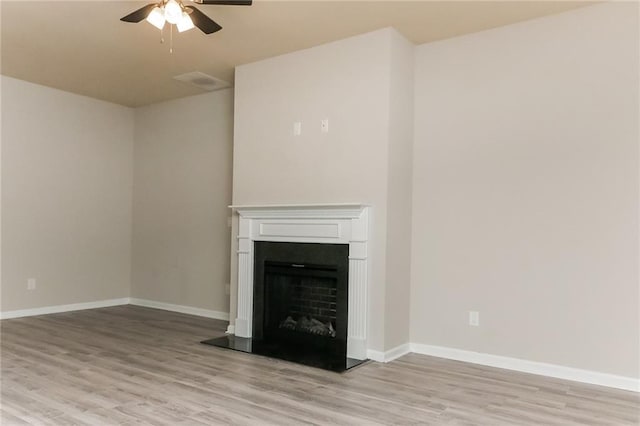 unfurnished living room with ceiling fan and light hardwood / wood-style flooring