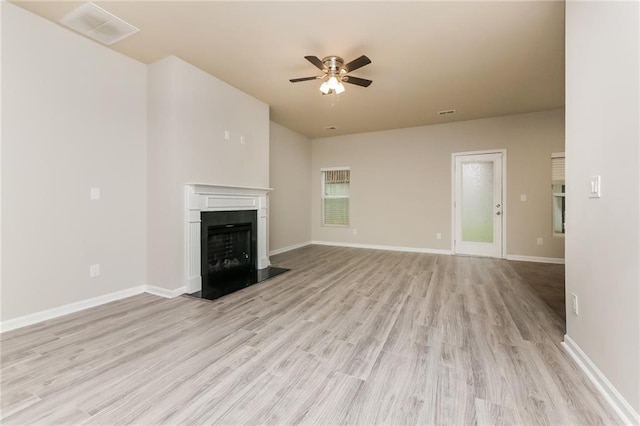 unfurnished living room with ceiling fan and light wood-type flooring