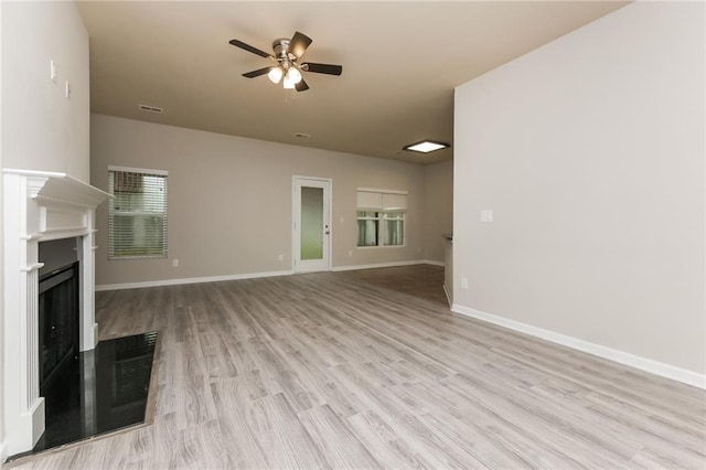 unfurnished living room featuring ceiling fan and light wood-type flooring