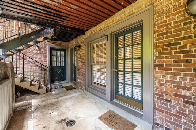 doorway to property featuring brick siding