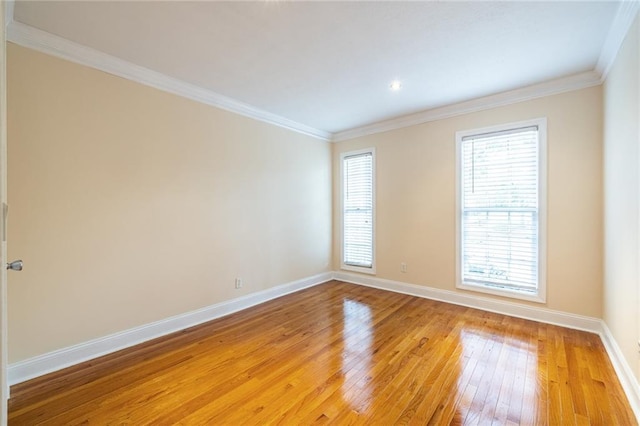 unfurnished room with light wood-style floors, baseboards, crown molding, and recessed lighting