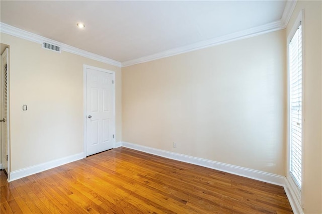 unfurnished bedroom with light wood-style flooring, crown molding, and baseboards