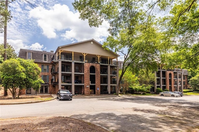 view of building exterior featuring uncovered parking