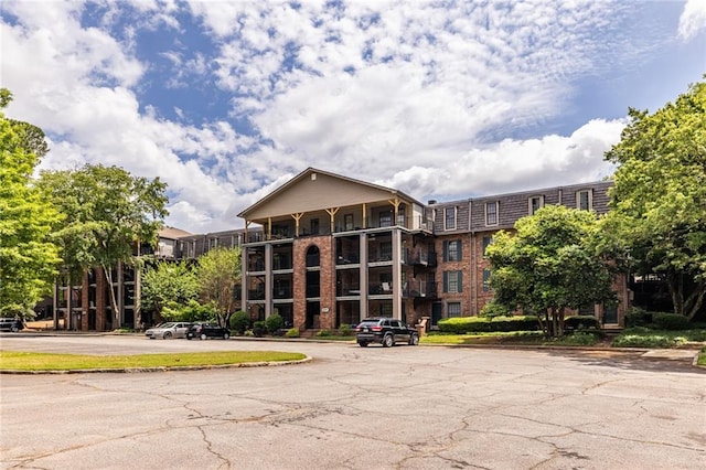 view of building exterior with uncovered parking