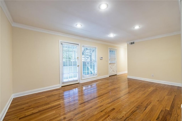 unfurnished room featuring wood finished floors, ornamental molding, recessed lighting, and baseboards