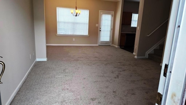 interior space with carpet flooring and a chandelier