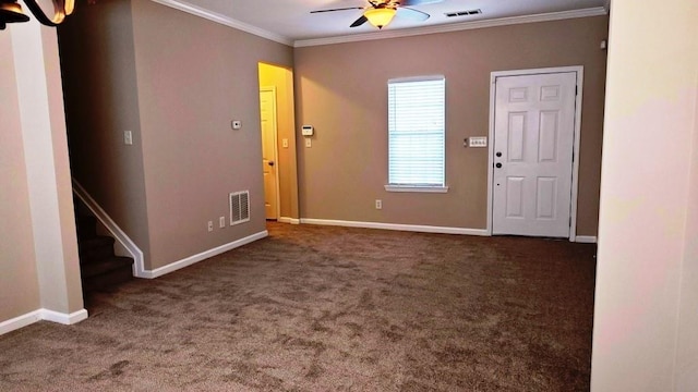 entrance foyer with dark carpet, ceiling fan, and crown molding