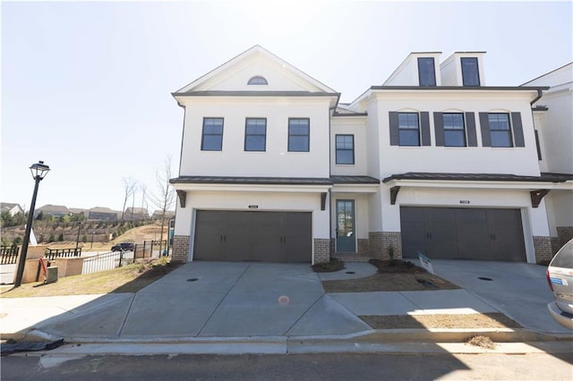 702 Dodd Ln Unit 159, Buford, GA 30518 - view of front of property featuring stucco siding, fence, brick siding, an attached garage, and concrete driveway