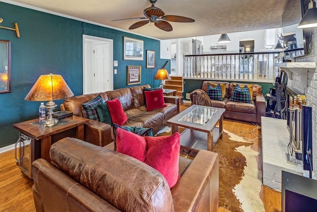 3519 Sunderland Way NE, Brookhaven, GA 30319 - living room with wood finished floors, a ceiling fan, a textured wall, a fireplace, and ornamental molding