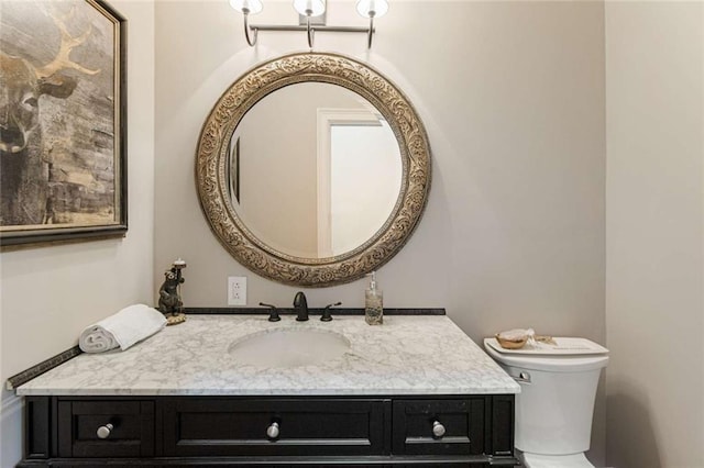 bathroom with toilet and vanity