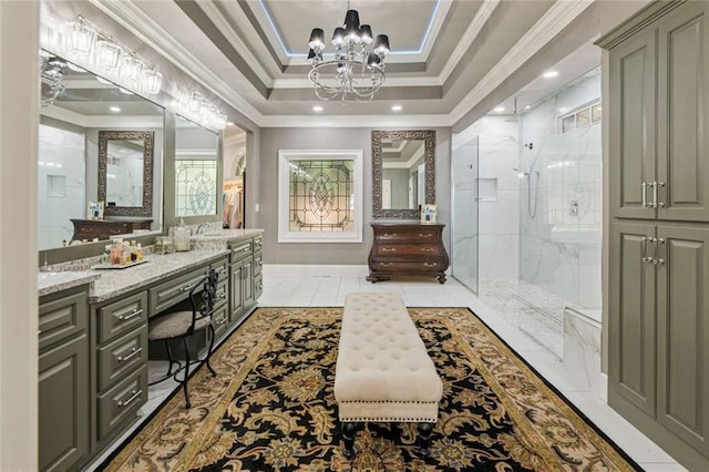 bathroom with vanity, a marble finish shower, ornamental molding, a raised ceiling, and a notable chandelier