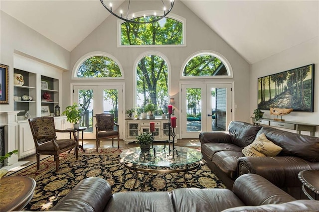 living room with wood finished floors, plenty of natural light, french doors, and a chandelier