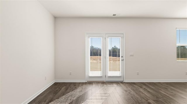 unfurnished room with dark wood-type flooring