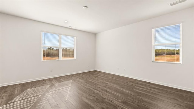 spare room with dark hardwood / wood-style floors