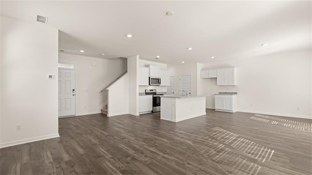 unfurnished living room with dark hardwood / wood-style floors and sink