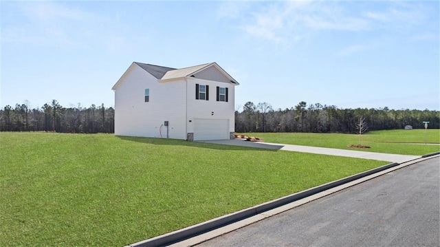 view of side of home featuring concrete driveway, a yard, and an attached garage