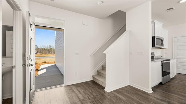 foyer with dark hardwood / wood-style floors