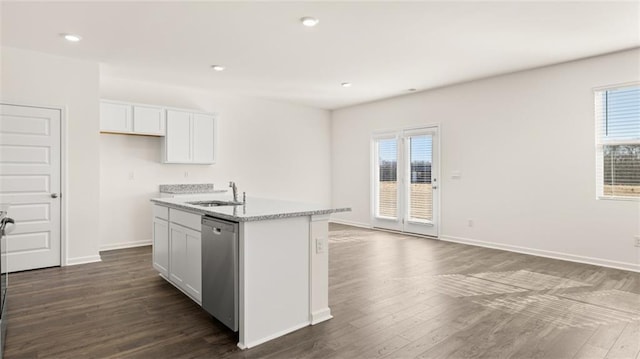 kitchen with a wealth of natural light, an island with sink, dishwasher, sink, and white cabinets