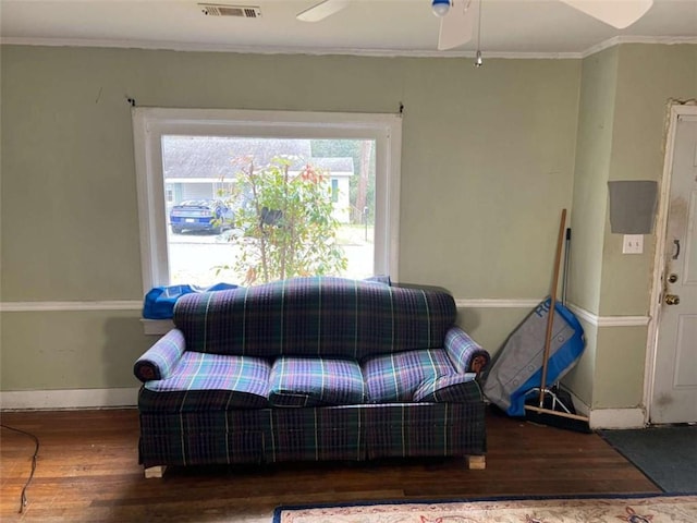 living room featuring ceiling fan, dark hardwood / wood-style flooring, and crown molding