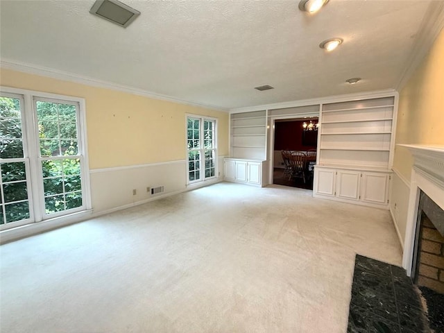 unfurnished living room featuring built in features, ornamental molding, a fireplace with flush hearth, light colored carpet, and a textured ceiling