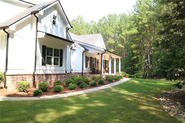 view of side of property with a lawn