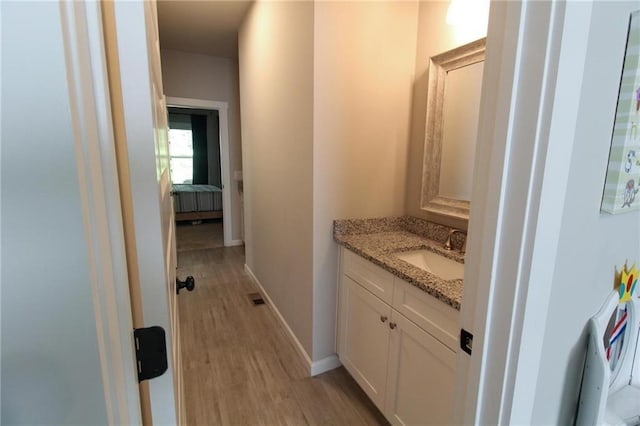 bathroom featuring vanity and hardwood / wood-style flooring