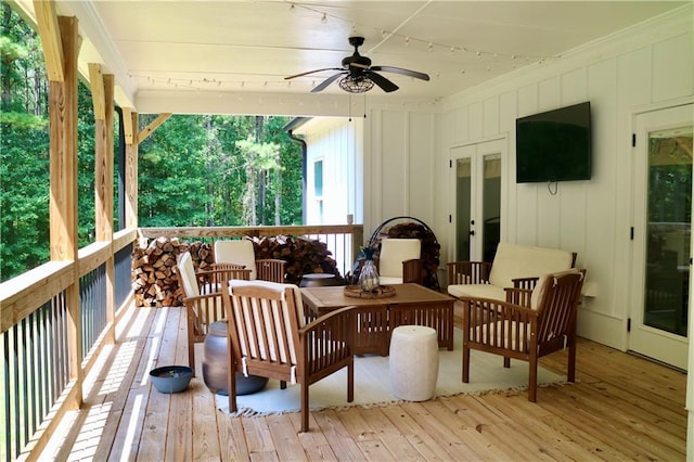 wooden deck with outdoor lounge area and ceiling fan