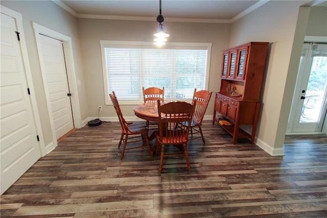 dining room with crown molding and dark hardwood / wood-style flooring