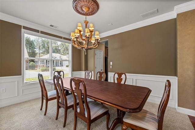 6350 Manningtree Ct, Cumming, GA 30041 - dining space featuring a chandelier, a wainscoted wall, light carpet, crown molding, and a decorative wall