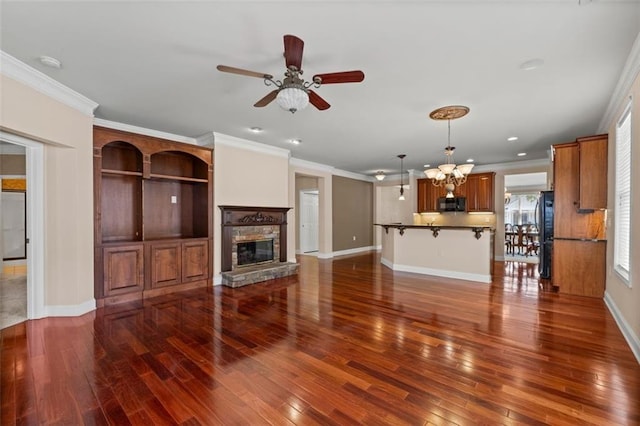 6350 Manningtree Ct, Cumming, GA 30041 - unfurnished living room with dark wood-type flooring, ceiling fan, a fireplace, baseboards, and ornamental molding