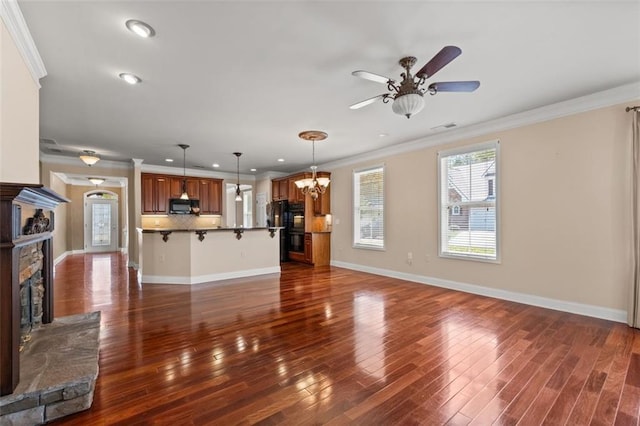 6350 Manningtree Ct, Cumming, GA 30041 - unfurnished living room featuring a fireplace, a ceiling fan, ornamental molding, dark wood-type flooring, and recessed lighting