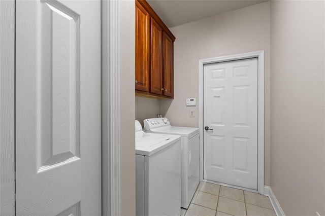 6350 Manningtree Ct, Cumming, GA 30041 - laundry room featuring washing machine and clothes dryer, cabinet space, light tile patterned floors, and baseboards