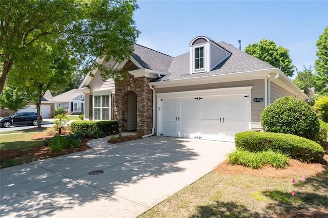 6350 Manningtree Ct, Cumming, GA 30041 - view of front of house featuring a garage, driveway, a shingled roof, and stone siding