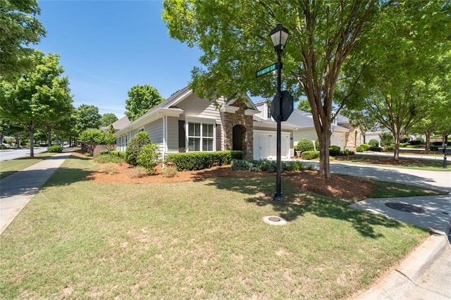 6350 Manningtree Ct, Cumming, GA 30041 - view of front of house with a front lawn, stone siding, driveway, and an attached garage