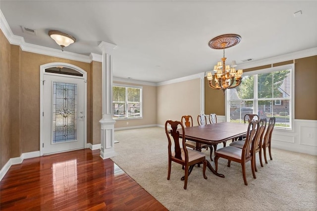 6350 Manningtree Ct, Cumming, GA 30041 - dining area with a chandelier, ornamental molding, wood finished floors, decorative columns, and a wainscoted wall
