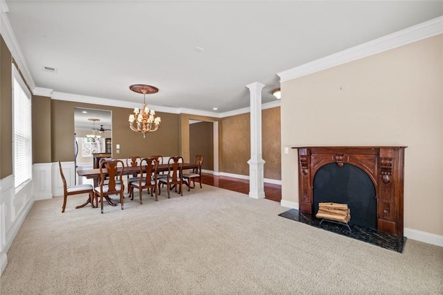 6350 Manningtree Ct, Cumming, GA 30041 - carpeted dining area featuring ornamental molding, a fireplace with flush hearth, decorative columns, and a chandelier