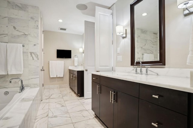 bathroom with two vanities, a sink, visible vents, marble finish floor, and a garden tub