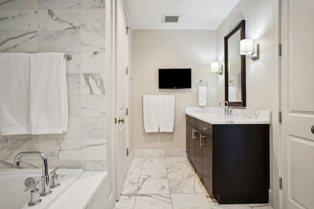 full bathroom featuring a bath, baseboards, visible vents, marble finish floor, and vanity