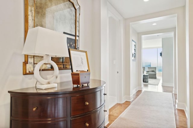 hall with recessed lighting, wood finished floors, and baseboards