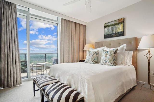bedroom featuring access to outside, expansive windows, carpet, and ceiling fan