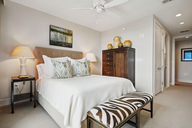 bedroom featuring baseboards, light carpet, visible vents, and recessed lighting