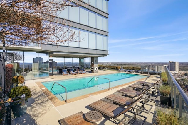 community pool with fence and a patio
